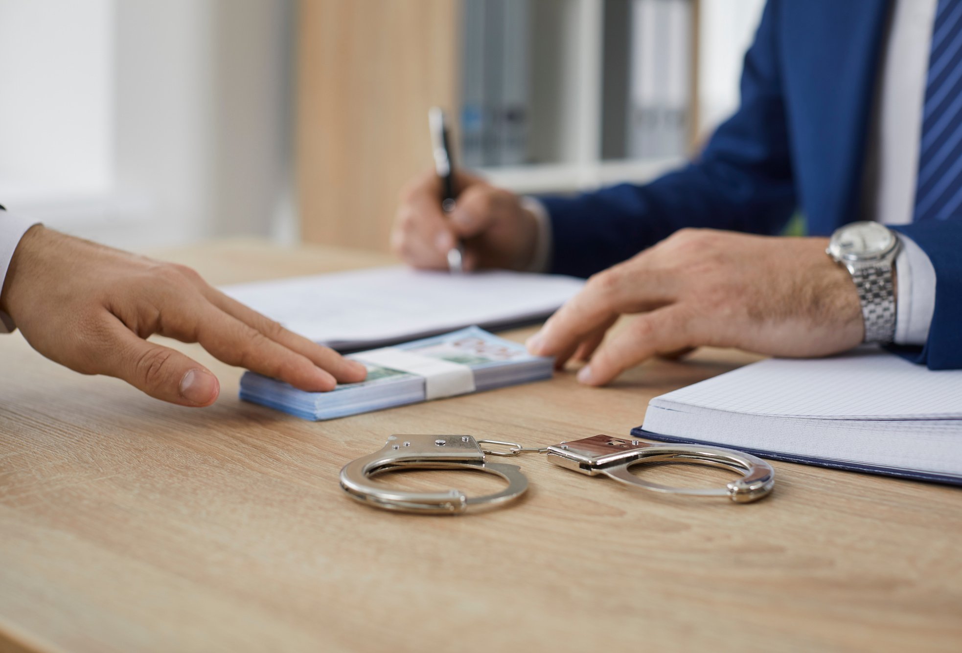 Man gives some money to a bondsman asking to release someone from prison on bail